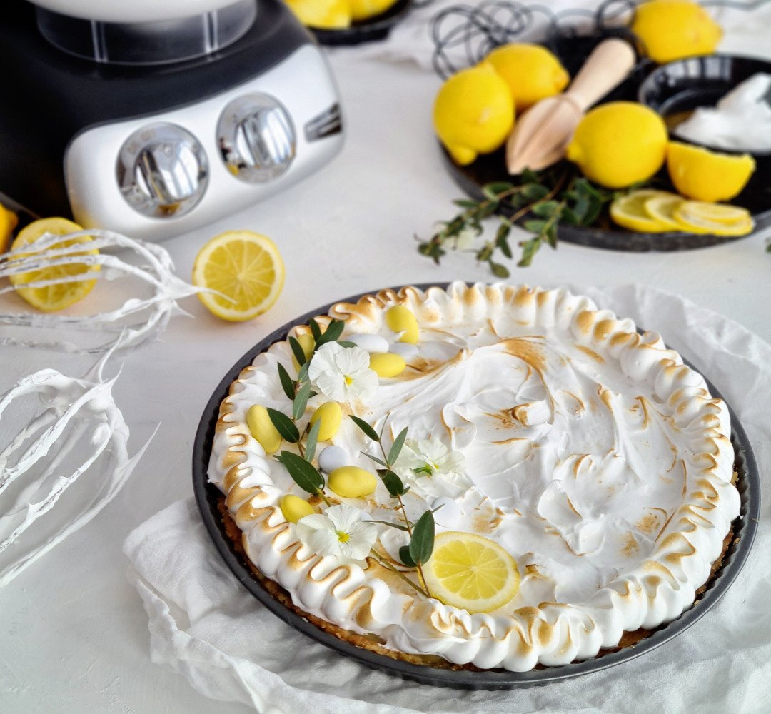 A lemon pie on a white table.