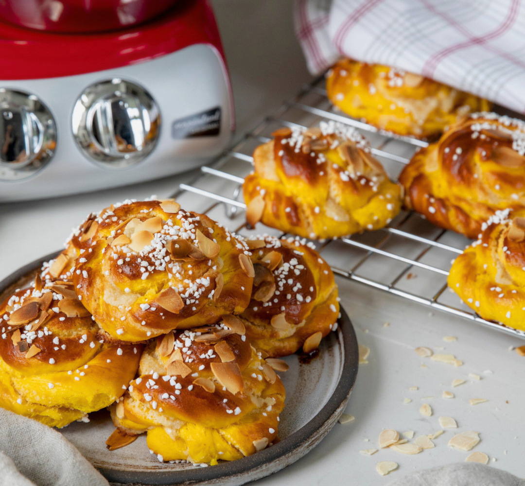 A plate of saffron buns on top of a counter.