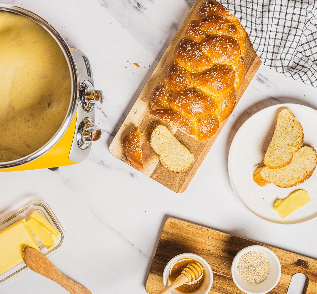 A table topped with bread and butter on top of a table.