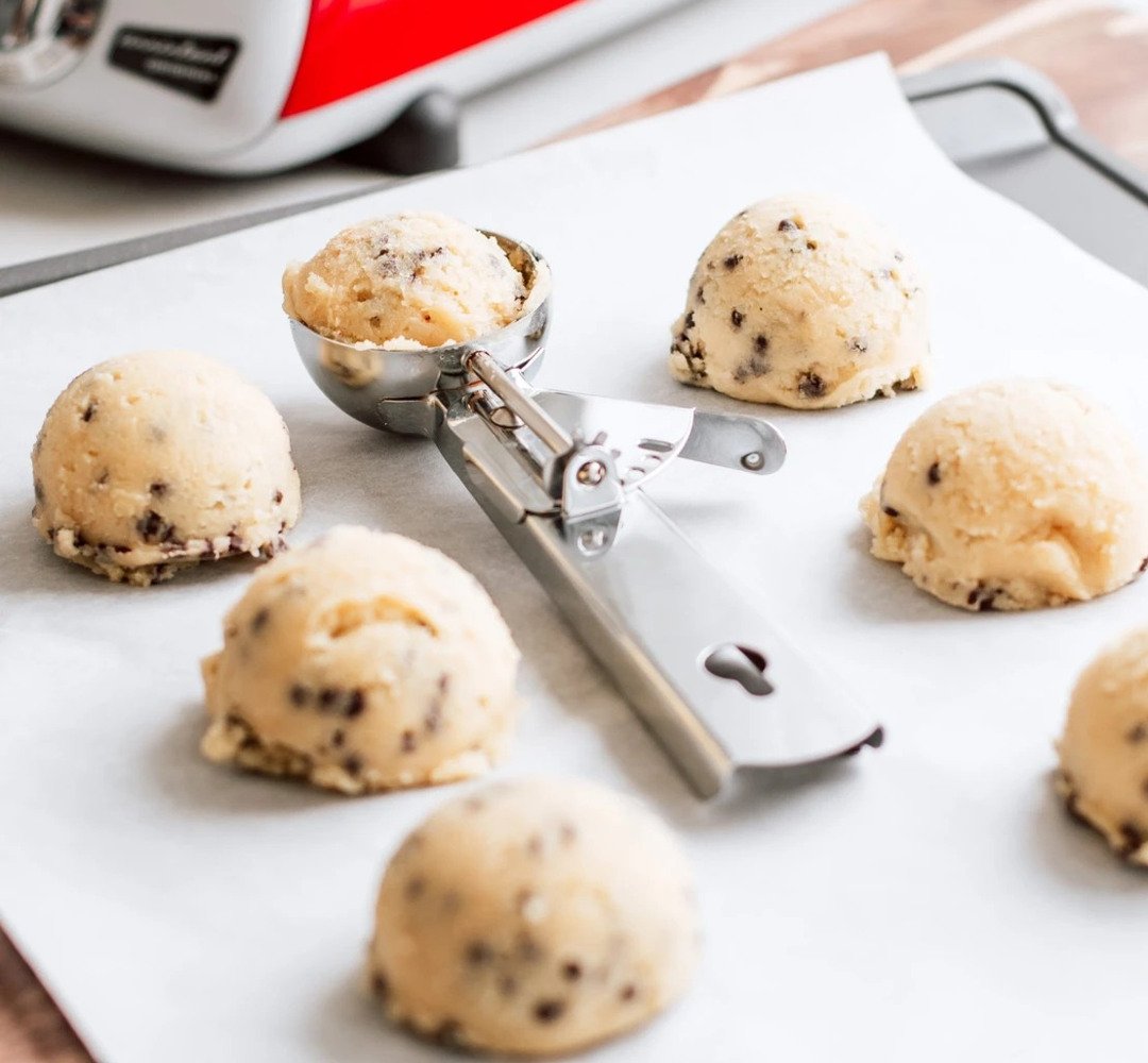 A tray of cookies with a cookie cutter on it.