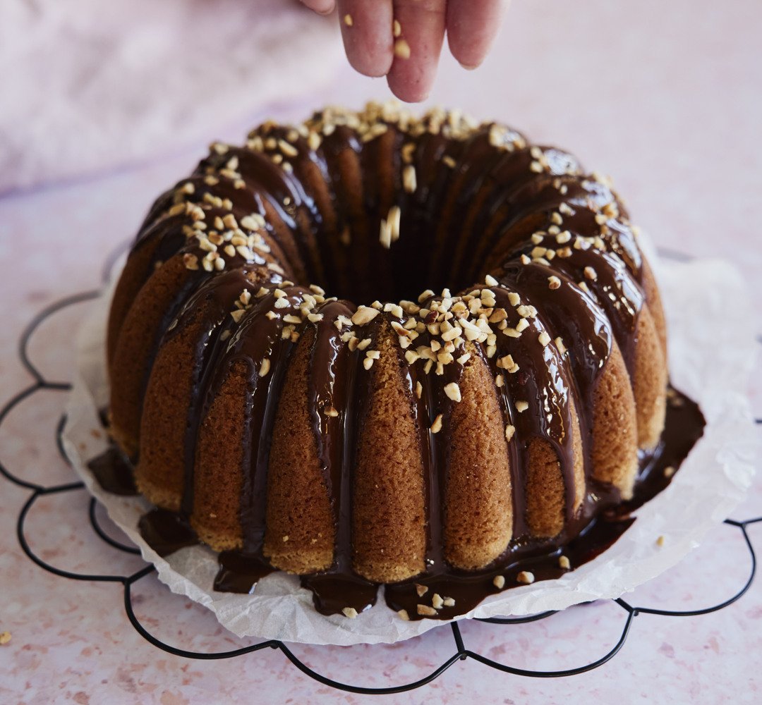 A bundt cake with chocolate icing and sprinkles.