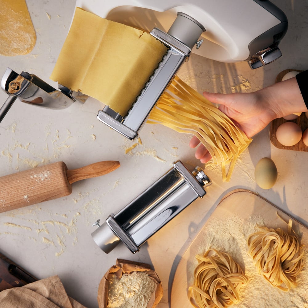 A person is making pasta on a table.