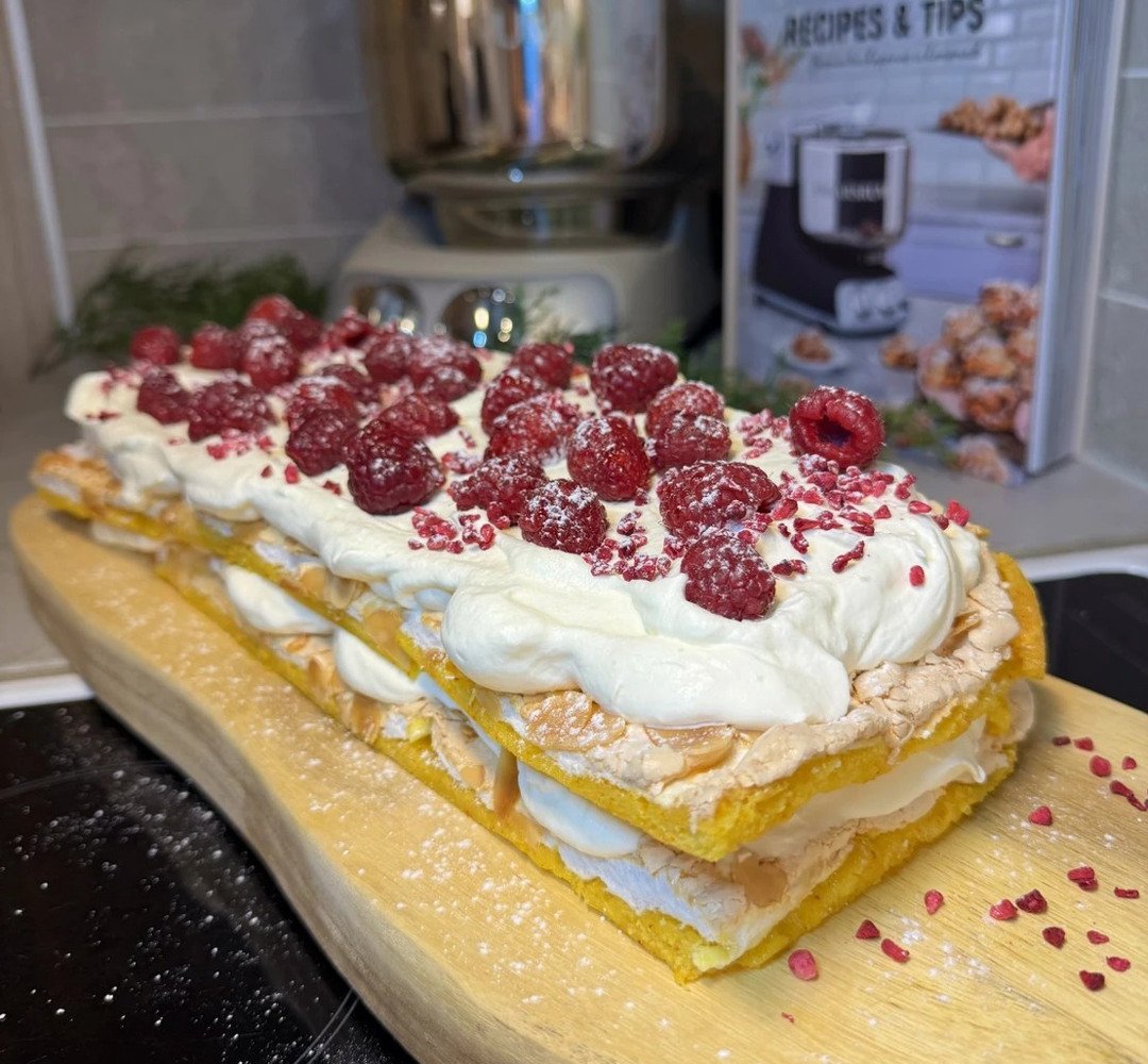 Saffron Meringue Cake on a wooden cutting board