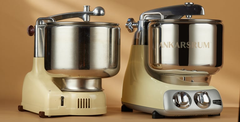 A couple of mixers sitting on top of a table.