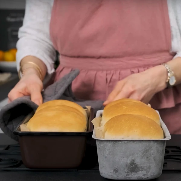 Two loaves of bread in pans.