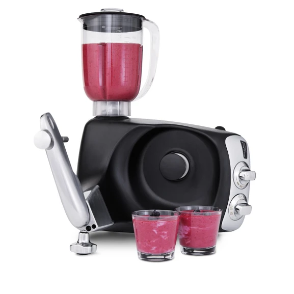 Ankarsrum Assistent Original with the Blender attached, blending a smoothie, with two glasses of finished smoothie beside it.